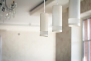 Chandelier in the interior of the room, lamps in white shades.