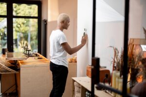 Latin man choosing temperature on thermostat